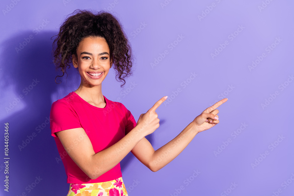 Photo of adorable lovely girl wear pink top pointing two fingers empty space isolated violet color background Photo of adorable lovely girl wear pink top pointing two fingers empty space isolated violet color background