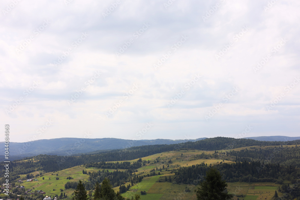 Beautiful view of forest in mountains under blue sky Beautiful view of forest in mountains under blue sky