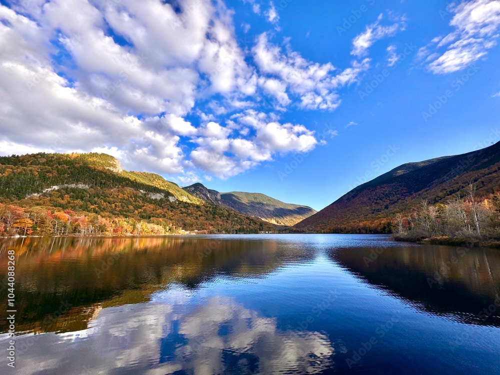 Fototapeta premium Fall landscape photo of mountains reflected in a lake.