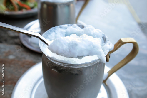 Tableau sur toile Traditional Turkish foamy buttermilk in a copper mug with a spoon