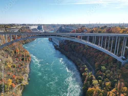 Aerial over the Niagara River and gorge view over the international border crossing Queenston-Lewiston bridge between New York, United States and Ontario, Canada in autumn.