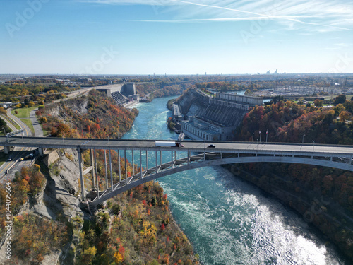 Aerial over the Niagara River and gorge view over the international border crossing Queenston-Lewiston bridge between New York, United States and Ontario, Canada during autumn.