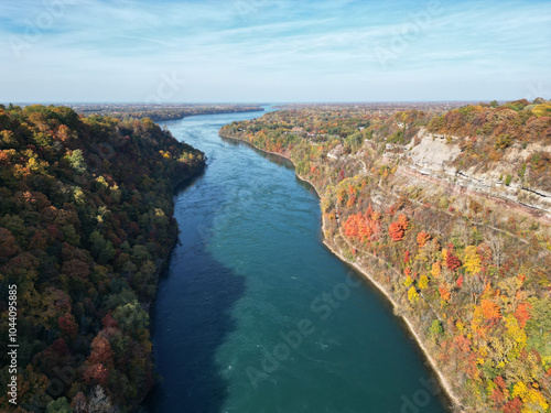 Aerial over the Niagara River and gorge between Lewiston, New York, United States and Ontario, Canada towards Lake Ontario. Shot during an autumn afternoon with colorful fall foliage trees in October. photo