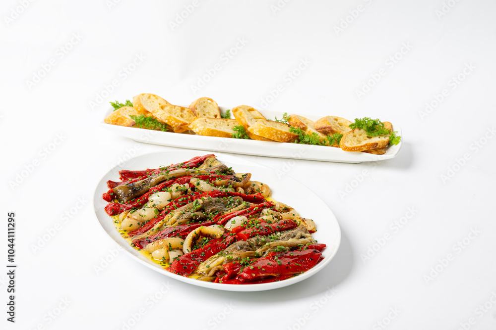 Roasted onions, eggplants and peppers on a platter with toast points in background Roasted onions, eggplants and peppers on a platter with toast points in background