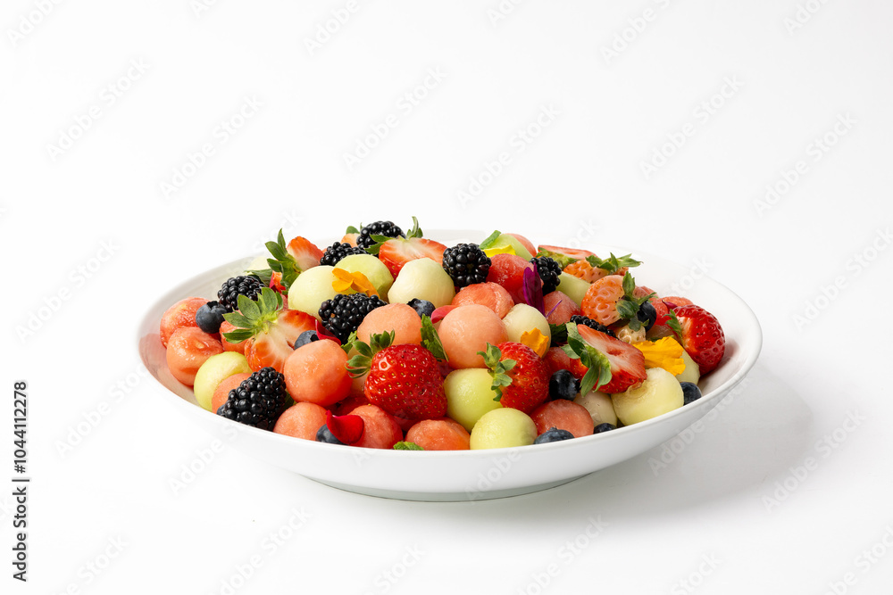 Large bowl of fresh fruit salad with melon balls and strawberries Large bowl of fresh fruit salad with melon balls and strawberries