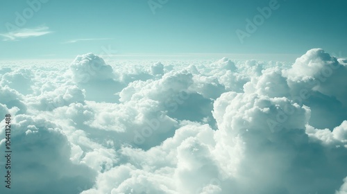 View of white clouds and blue sky from an airplane window. 