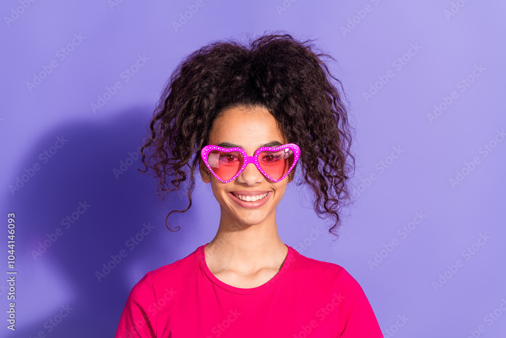 Photo of charming positive woman wear pink top sunglass smiling empty space isolated violet color background Photo of charming positive woman wear pink top sunglass smiling empty space isolated violet color background