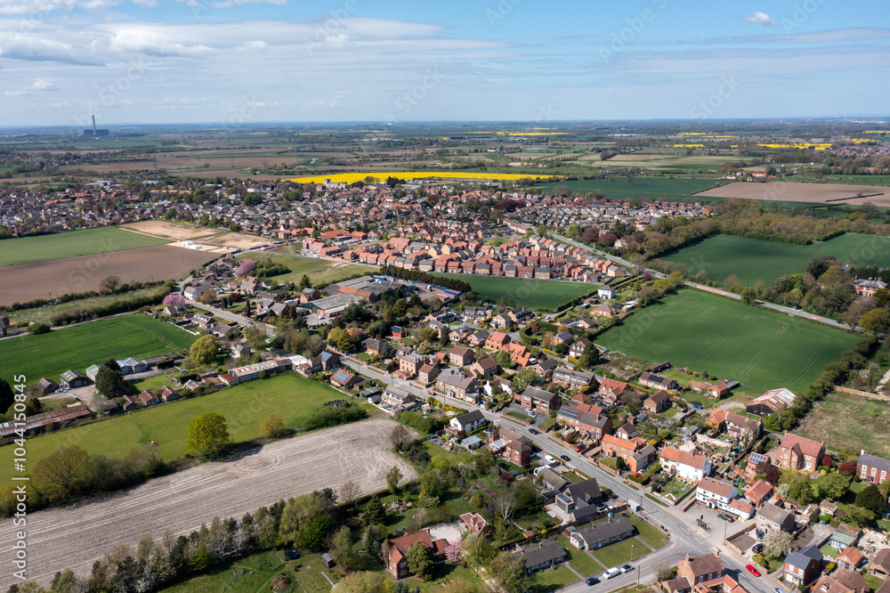 Aerial drone photo of the village of West Cowick in Goole in the East Riding of Yorkshire England showing the streets and houses and homes in the British village in the summer time