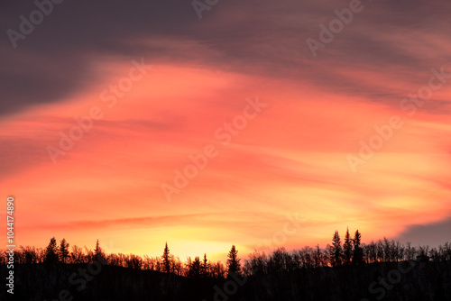 red dramatic skies with mountain scenery during winter