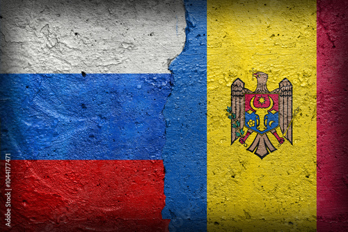 Russia and Moldova - Cracked concrete wall painted with a Russian flag on the left and a Moldovan flag on the right stock photo