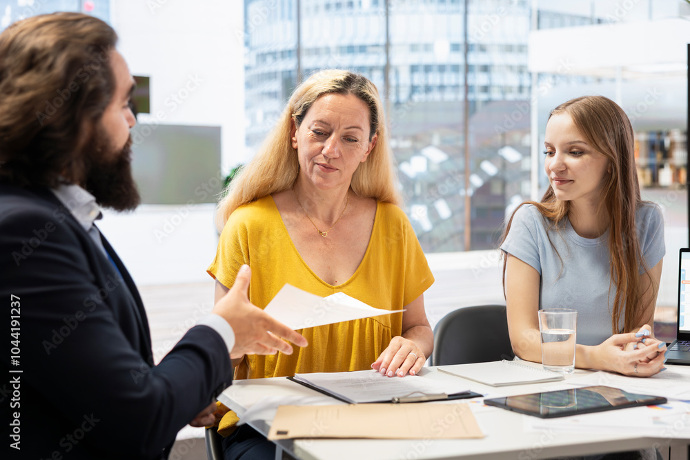 Fototapeta premium Counselor helping parent and teenager build financial plan detailing economic goals and available cash flow, improving their budget. Agent recommending customers how to improve financial situation