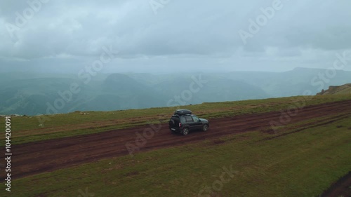 Aerial photography of car movement in the mountains, SUV driving on a mountain road, aerial photography of a road in the North Caucasus, aerial photography of a road in the mountains, lada niva travel photo