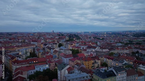 Wallpaper Mural Captivating twilight bathes Prague's skyline, revealing iconic red roofs under a dramatic, cloud filled sky. The scene showcases the city's rich architectural heritage and timeless charm Torontodigital.ca