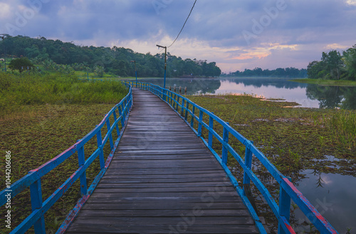 Long wooden bridge on a Tranquil Lake