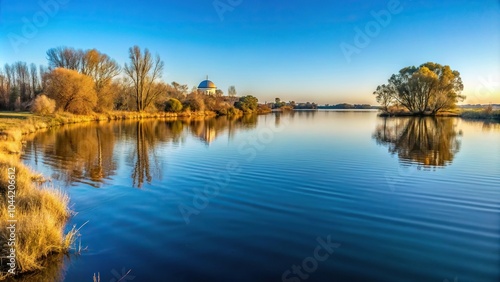 Scenic winter landscape of Vaal River with small ripples and snow-capped Dome Bergland banks photo