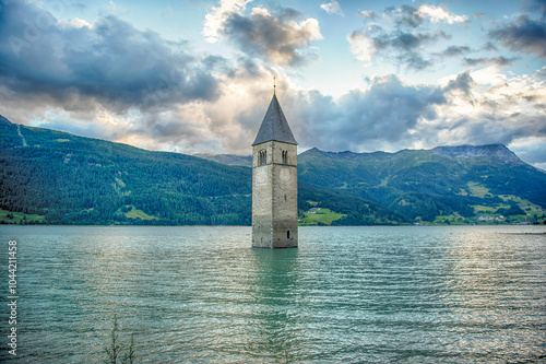 The iconic submerged Church Tower of Graun, Lake Reschensee, Italy photo