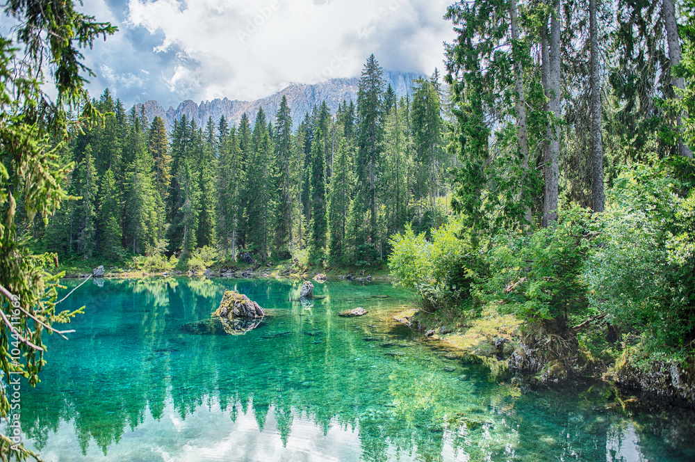 Fototapeta premium The emerald green Lake Carezza reflecting Latemar mountain, Dolomites, Italy