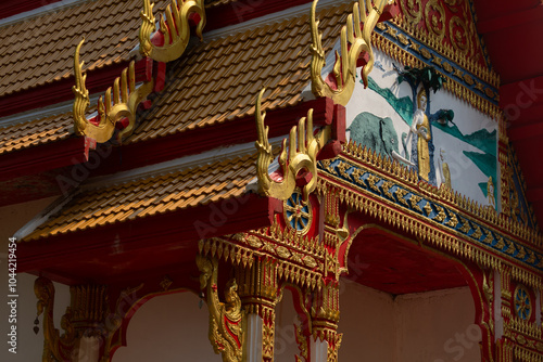 Traditional decorative ornaments and reliefs, on the roof and facade of a Buddhist temple on the island of Koh Chang, Thailand photo