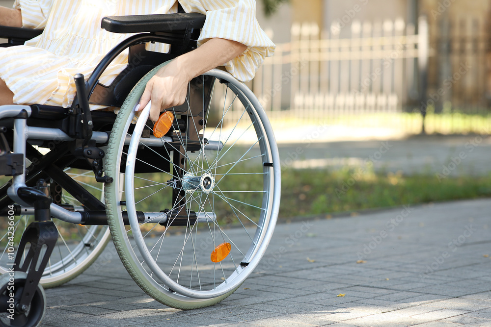 Woman in wheelchair outdoors, closeup Woman in wheelchair outdoors, closeup