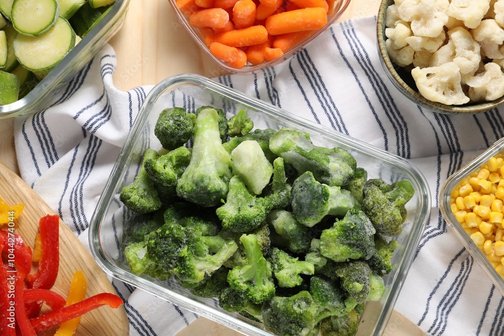 Different frozen vegetables on wooden table, top view Different frozen vegetables on wooden table, top view
