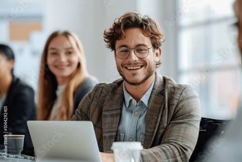 Smiling young businessman and woman collaborating in an office