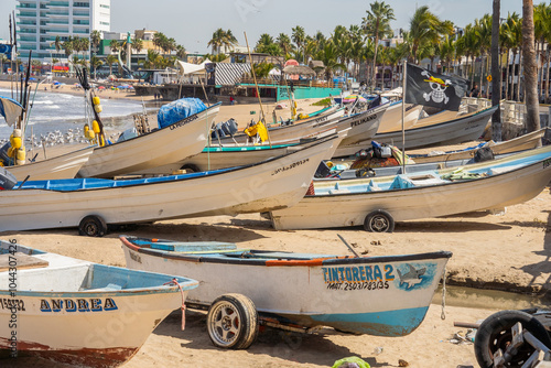 Artisanal fishing boats on the beach in Mazatlan, Mexico photo