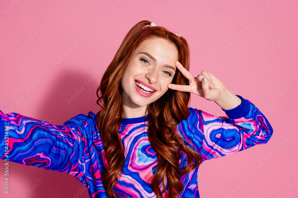 Photo portrait of pretty young girl take selfie photo v-sign wear trendy blue colorful outfit isolated on pink color background Photo portrait of pretty young girl take selfie photo v-sign wear trendy blue colorful outfit isolated on pink color background