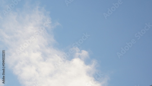 view of the blue sky with mountains and roofs of houses, in the sky there are kites