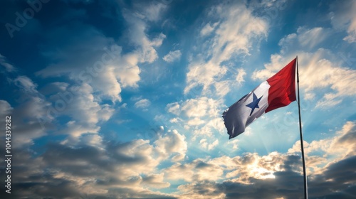 The Panamanian flag prominently waves in the foreground against a backdrop of dramatic clouds and a vibrantly illuminated sky during sunset, symbolizing national pride.