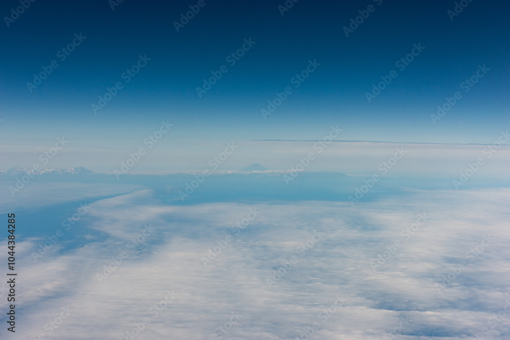 Fototapeta premium View from an airplane of the Kuril Islands and Sea of Okhotsk on a flight from Vancouver to Tokyo