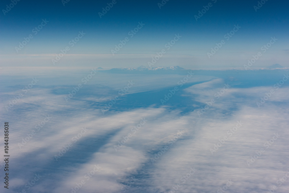 Obraz premium View from an airplane of the Kuril Islands and Sea of Okhotsk on a flight from Vancouver to Tokyo