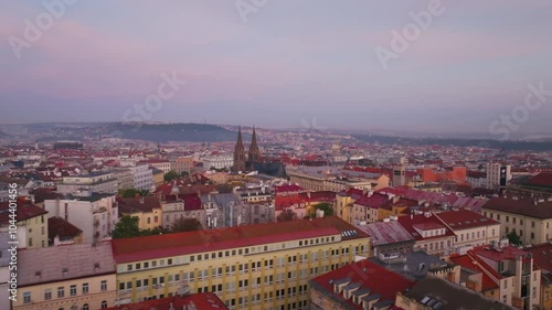 Aerial views showcase Prague's captivating skyline at twilight, featuring the beautiful Church of St. Henry and Kunhuta against a backdrop of vibrant clouds and gentle evening light photo