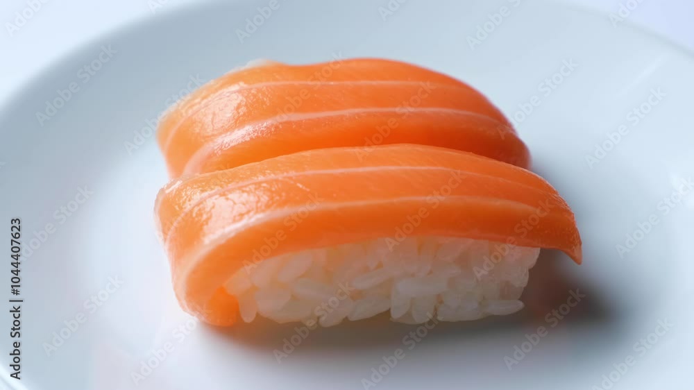 Closeup of salmon nigiri sushi on the white plate. Closeup of salmon nigiri sushi on the white plate.