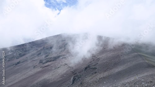 Clouds are rapidly moving across the sky above the Hoei Crater on Mt.Fuji, and focus moves to bottom. 4k 10bit footage photo