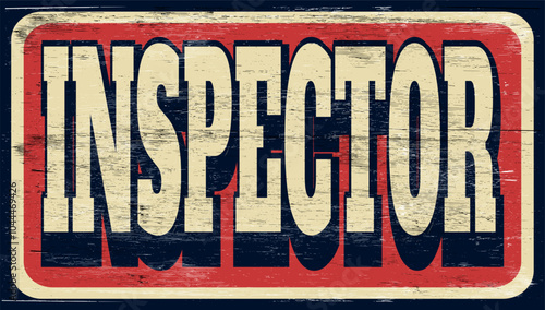 Aged vintage inspector sign on wood