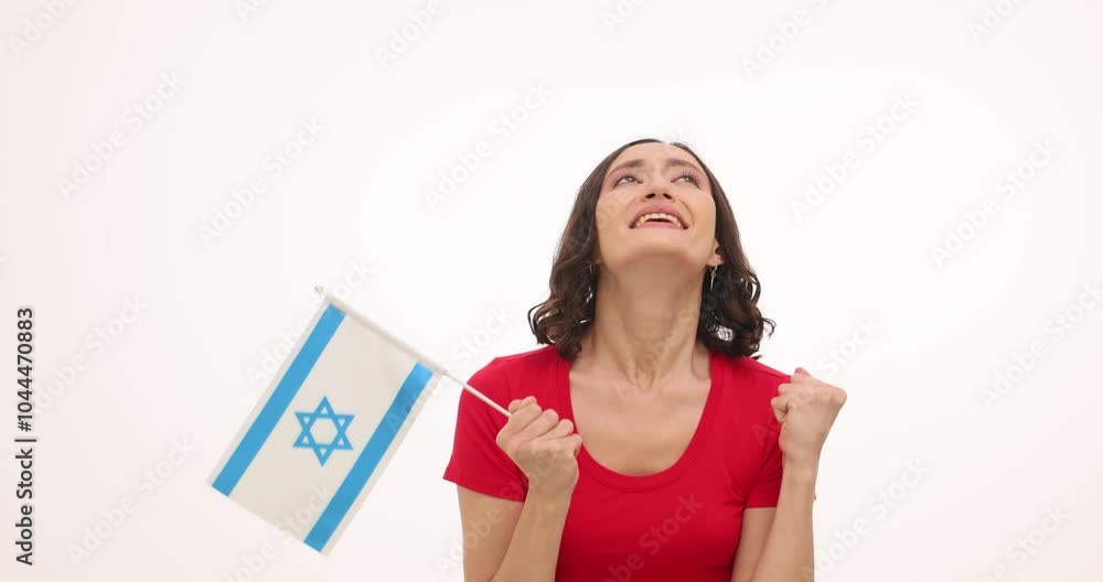 Woman holds flag of Israel showing support for country on white background. Female expresses happiness celebrating sports achievements of country Woman holds flag of Israel showing support for country on white background. Female expresses happiness celebrating sports achievements of country