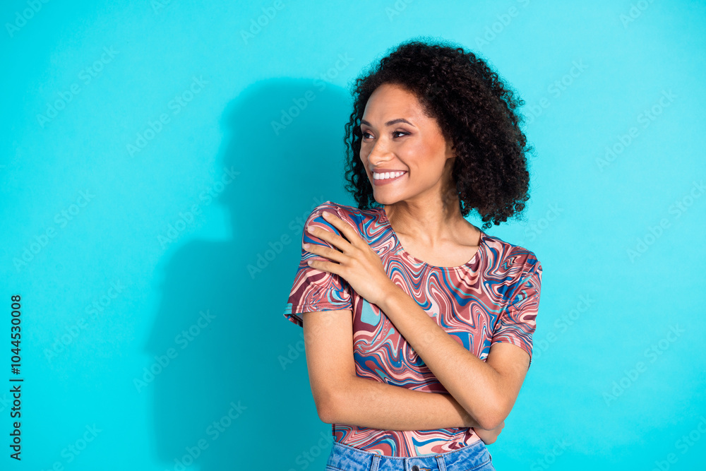 Photo of pretty young girl embrace self shoulders look empty space wear trendy colorful clothes isolated on aquamarine color background Photo of pretty young girl embrace self shoulders look empty space wear trendy colorful clothes isolated on aquamarine color background