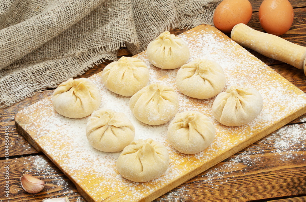 Khinkali with meat frozen on a wooden board Khinkali with meat frozen on a wooden board
