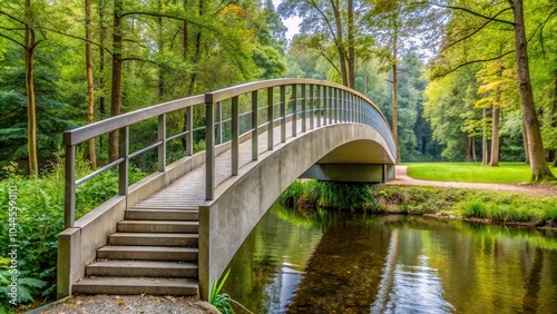 Modern concrete pedestrian bridge over small river in forest or garden footbridge at water level extreme close-up