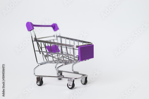 Miniature shopping Cart against white background,  online shopping concept  photo