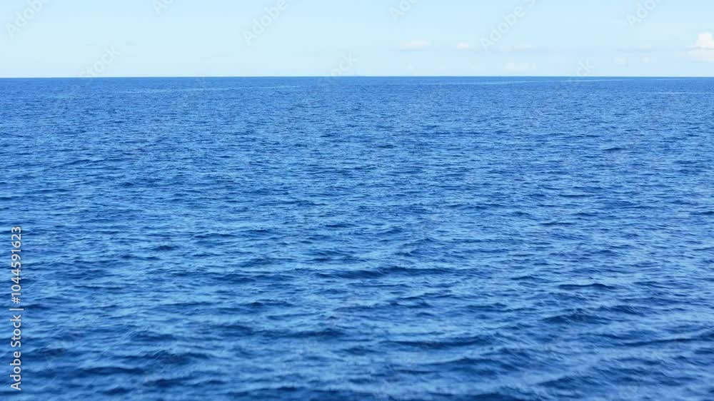 Aerial of open ocean with calm waves, a peaceful and minimalistic background with endless blue water Aerial of open ocean with calm waves, a peaceful and minimalistic background with endless blue water