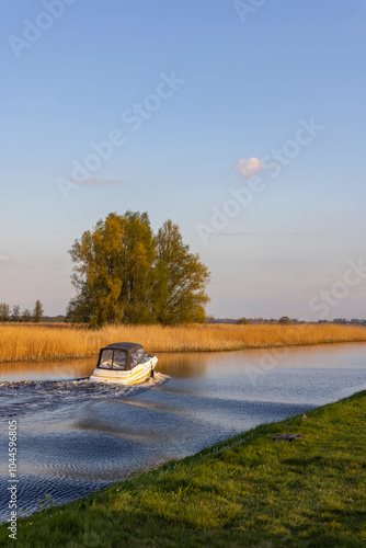 A water canal with a small boat nearby Steenwijk - Vollenhove  near Zwolle, The Netherlands photo