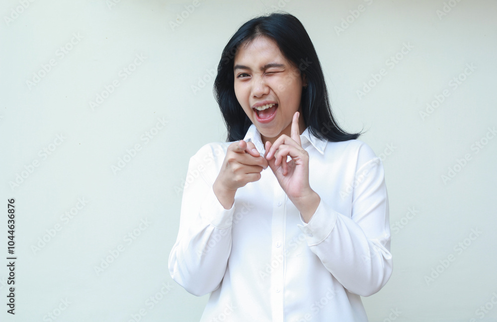 carefree successful asian young business woman excited pointing index finger forward and blink eye flirting to camera wearing white formal suit shirt, smiling broadly, isolated on white background carefree successful asian young business woman excited pointing index finger forward and blink eye flirting to camera wearing white formal suit shirt, smiling broadly, isolated on white background
