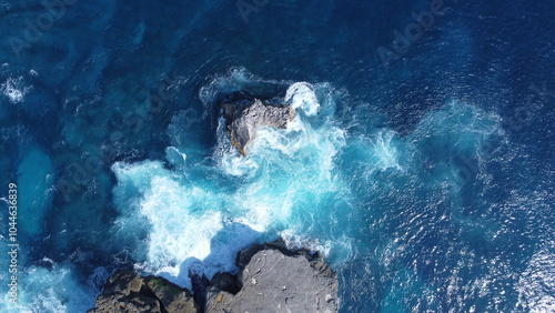 Drone photo of waves crashing onto the coastline 