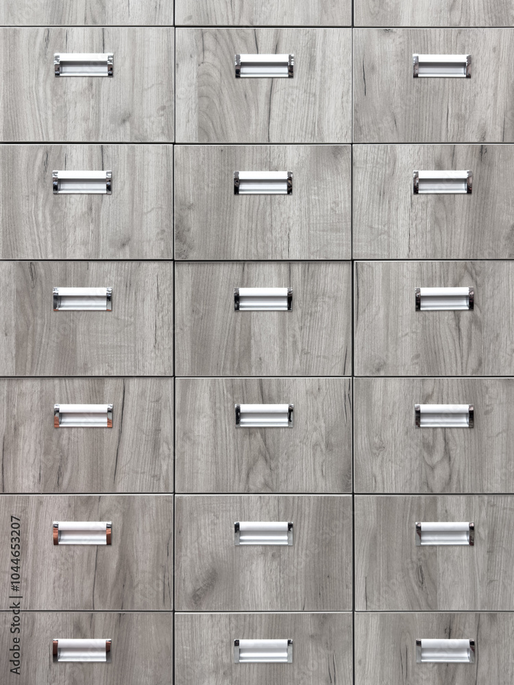 A row of wooden drawers with metal handles A row of wooden drawers with metal handles