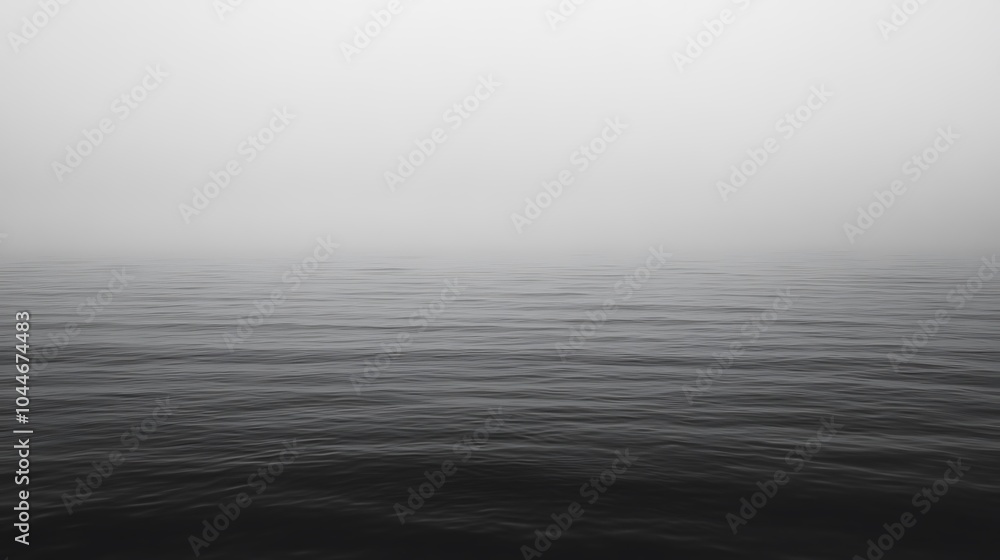 Calm, still water surface obscured by dense fog. Calm, still water surface obscured by dense fog.