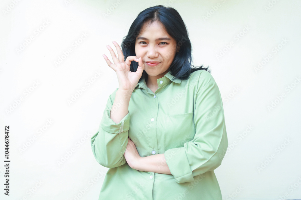 content glad asian woman wearing green over size shirt showing ok signs, approval gesture, looking at camera with grateful expression giving compliment, standing isolated background content glad asian woman wearing green over size shirt showing ok signs, approval gesture, looking at camera with grateful expression giving compliment, standing isolated background