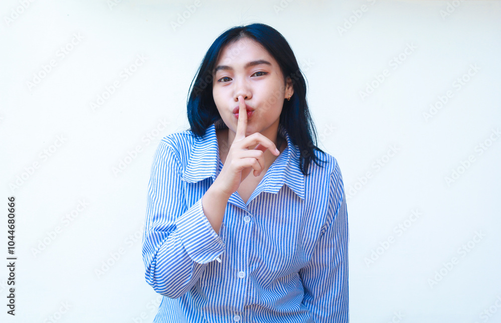 happy asian woman wearing striped shirt touch lips with finger show silence gesture with folded arms isolated on white background happy asian woman wearing striped shirt touch lips with finger show silence gesture with folded arms isolated on white background