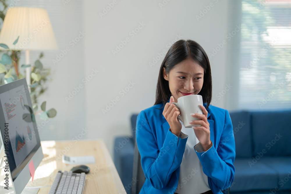Young businesswoman enjoys a cup of coffee during a break from her busy workday, finding a moment of relaxation and rejuvenation Young businesswoman enjoys a cup of coffee during a break from her busy workday, finding a moment of relaxation and rejuvenation