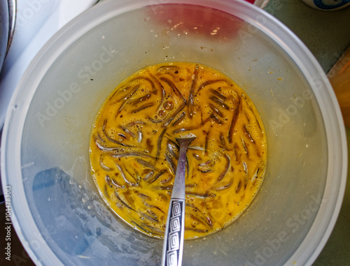 Valokuva A whitebait pattie or fritter egg mix ready to be poured into a frying pan to make a whitebait sammy, New Zealand